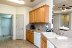 Fully equipped kitchen with coffee maker, dishwasher, and ice maker